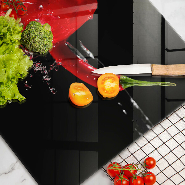 Skleněná deska do kuchyně Červené papriky ve vodě