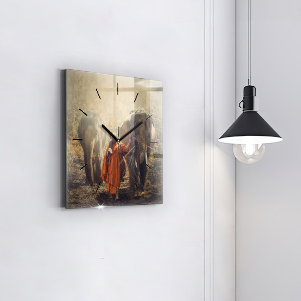Čtvercové nástěnné hodiny Mnich vedoucí slony