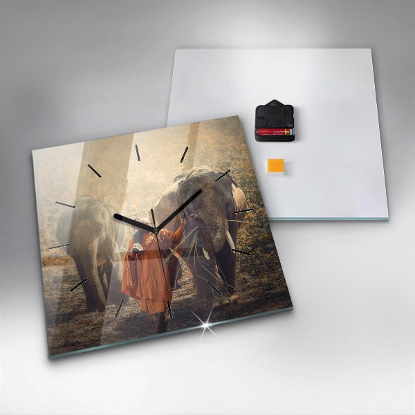 Čtvercové nástěnné hodiny Mnich vedoucí slony